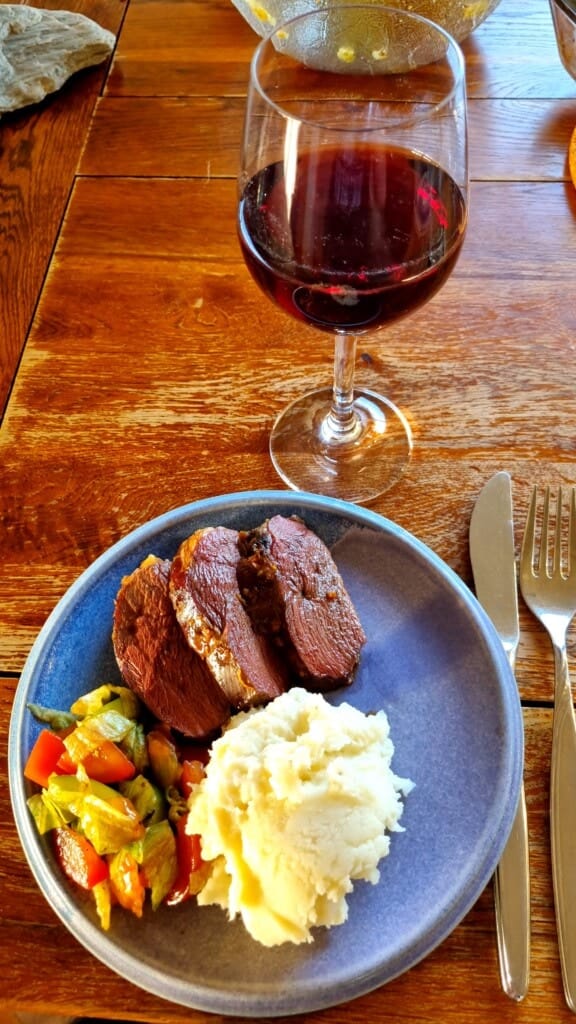 Plate with slices of dark meat with potato mash and garden salad